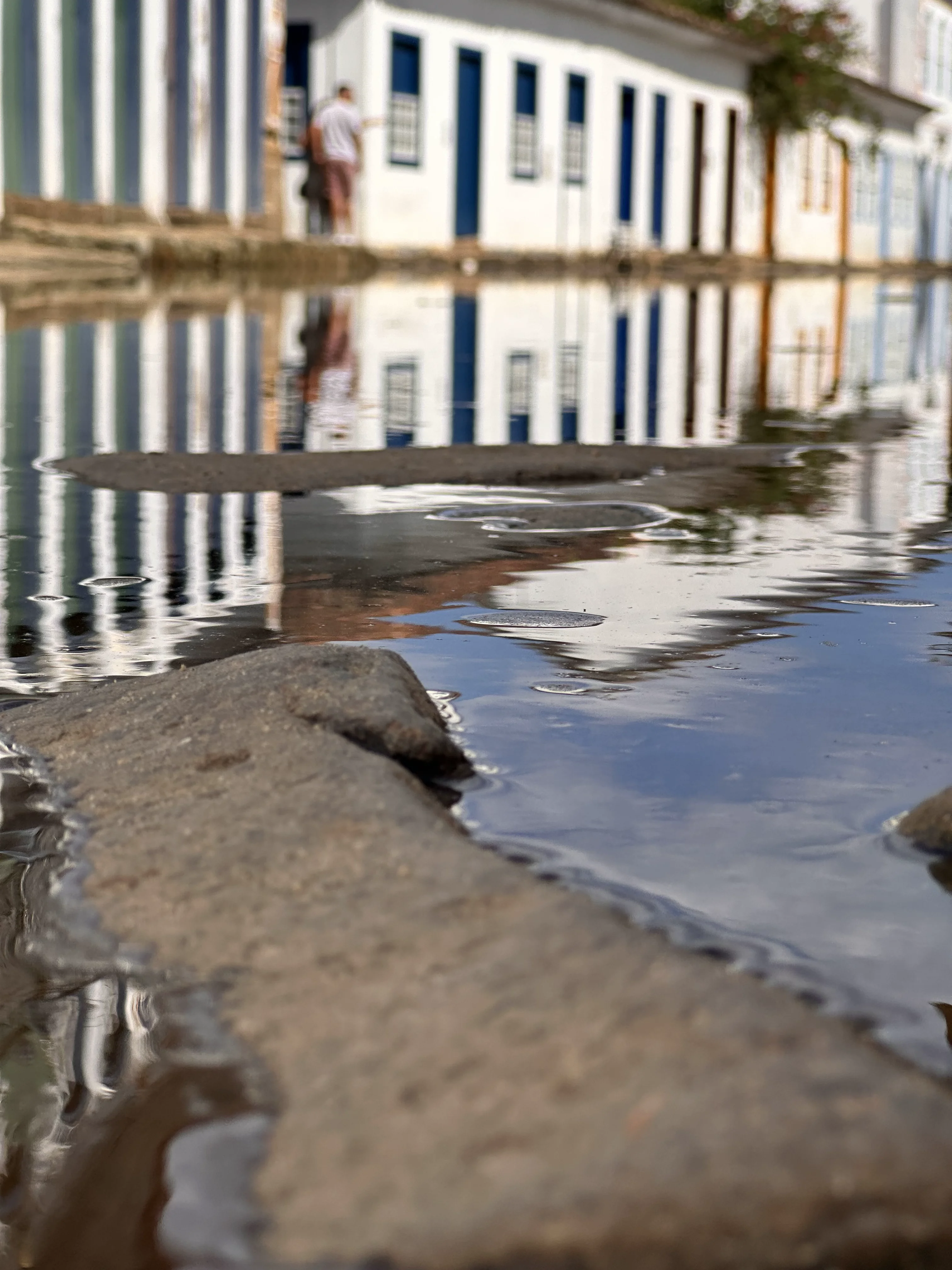High tide flowing through the cobblestone streets of Paraty's Historic Center.