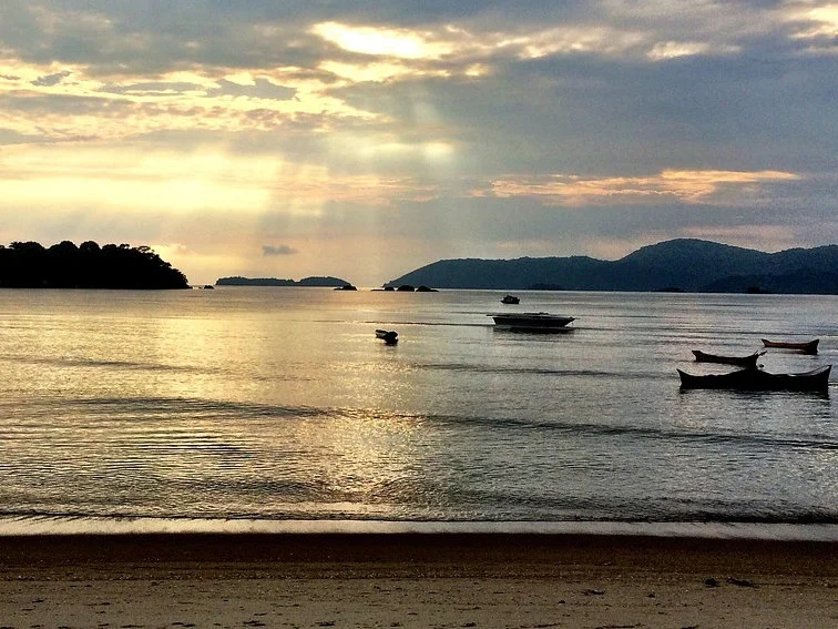 Relaxing at Jabaquara Beach as the sun begins to set over Paraty Bay.
